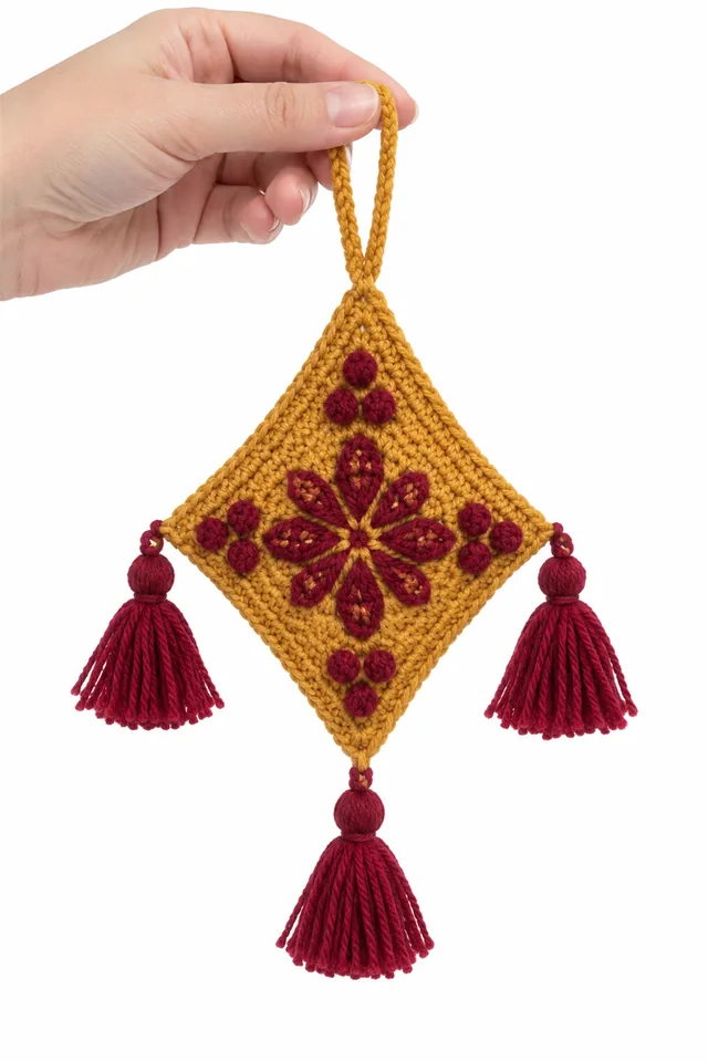 AI concept of an ochre crochet ornament shaped like a diamond kite with tail.