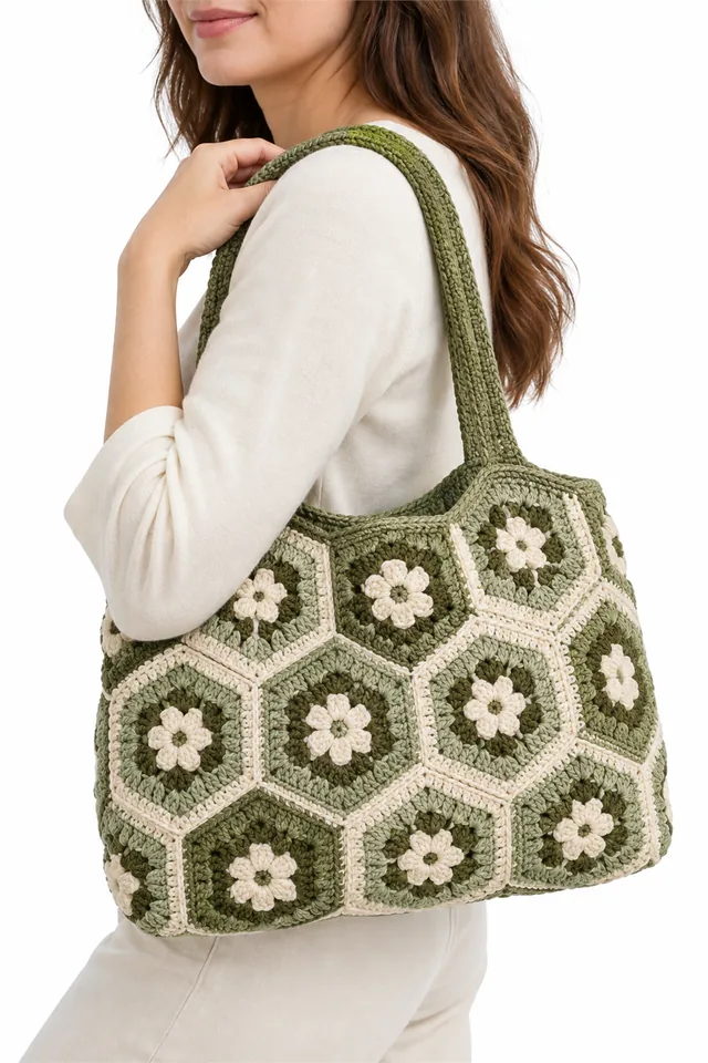 AI concept of a sage green crochet shoulder bag made of granny hexagons.