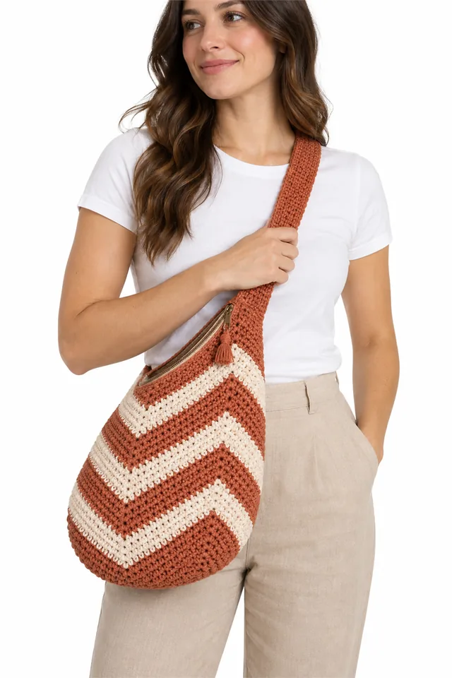 AI concept of a terracotta crochet sling bag with chevron pattern.